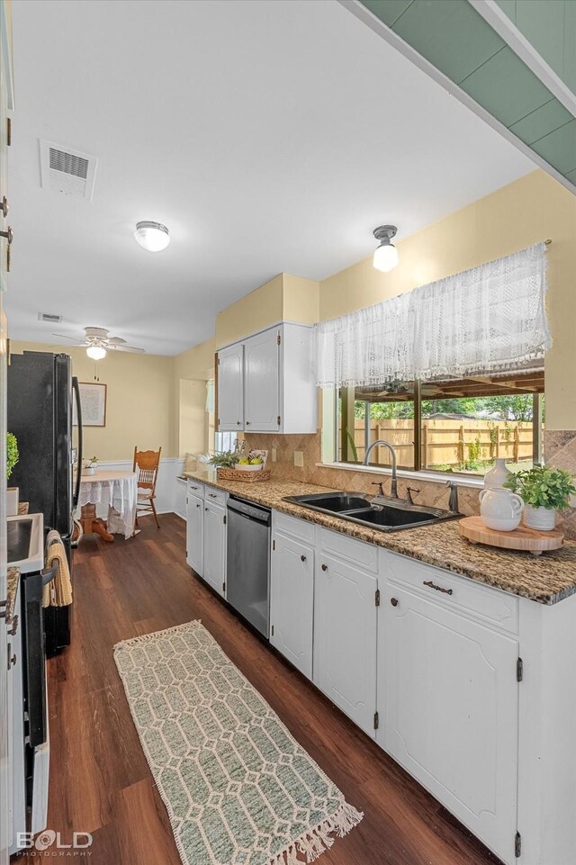 110 Elmview Ln, Haughton, LA 71037 - kitchen with stainless steel dishwasher, white cabinetry, stove, and backsplash