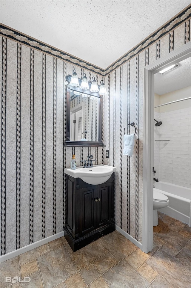 110 Elmview Ln, Haughton, LA 71037 - bathroom featuring a textured ceiling, vanity, shower / washtub combination, stone finish floors, and wallpapered walls