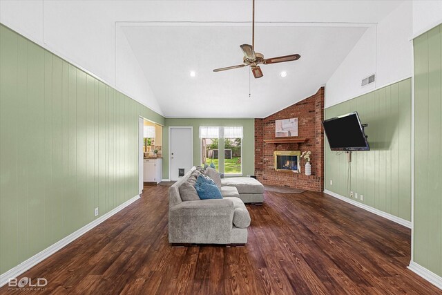110 Elmview Ln, Haughton, LA 71037 - living area with lofted ceiling, wood finished floors, ceiling fan, a brick fireplace, and wooden walls