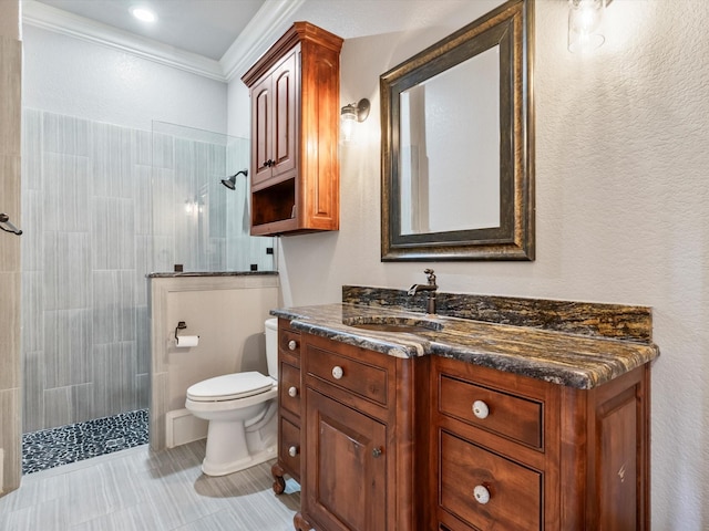 830 Cemetery Rd, Decatur, TX 76234 - bathroom featuring vanity, a tile shower, ornamental molding, and tile patterned flooring