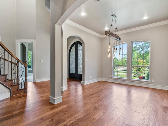 830 Cemetery Rd, Decatur, TX 76234 - entrance foyer with arched walkways, crown molding, wood finished floors, and recessed lighting