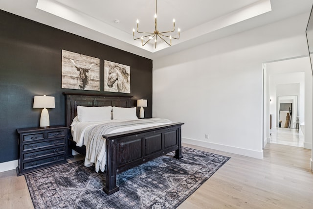 1890 Mcconnell Rd, Gunter, TX 75058 - bedroom with a chandelier, a raised ceiling, and light wood finished floors