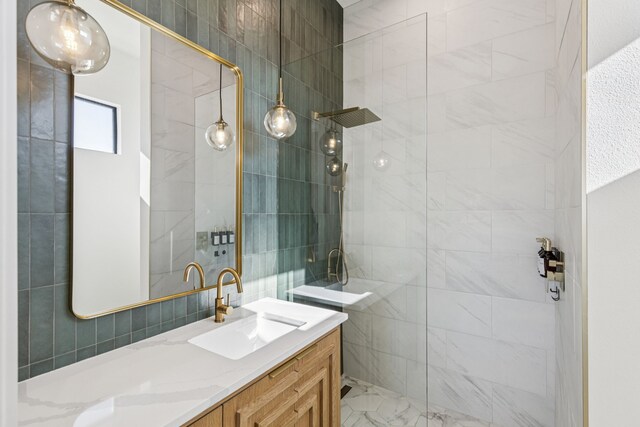 1890 Mcconnell Rd, Gunter, TX 75058 - bathroom featuring vanity, a tile shower, marble finish flooring, and tile walls