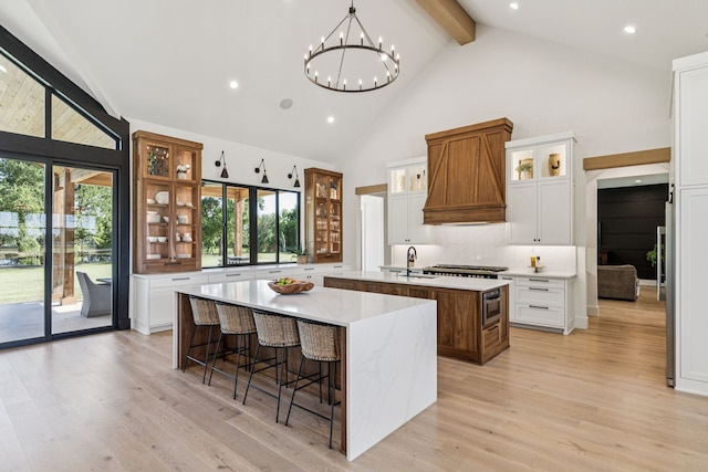 1890 Mcconnell Rd, Gunter, TX 75058 - kitchen with a large island, beam ceiling, plenty of natural light, high vaulted ceiling, and light wood-style flooring