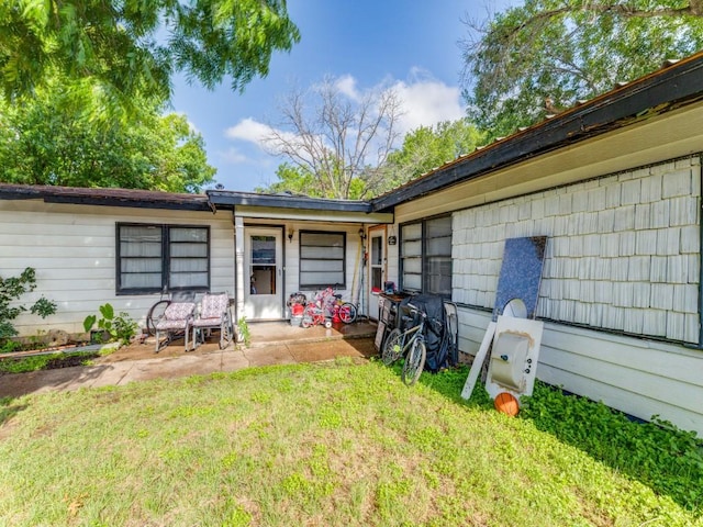 1405 NE 37th St, Fort Worth, TX 76106 - view of exterior entry with a lawn