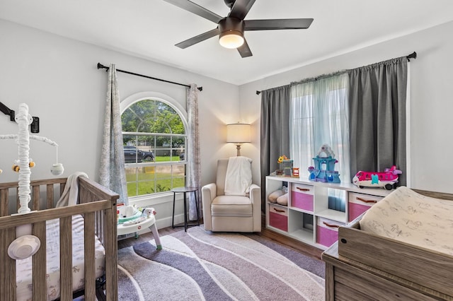 1204 Maxfield St, Bellmead, TX 76705 - bedroom with wood finished floors, a crib, and ceiling fan