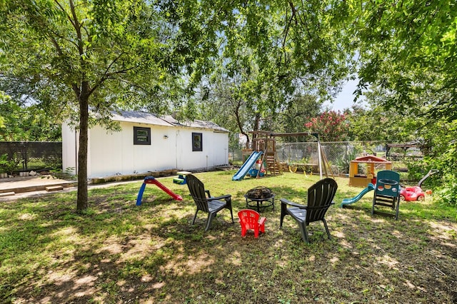 1204 Maxfield St, Bellmead, TX 76705 - fenced backyard featuring a playground and an outdoor fire pit