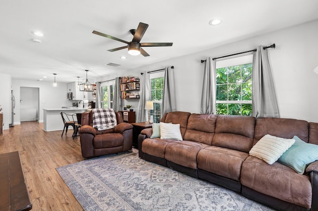 1204 Maxfield St, Bellmead, TX 76705 - living area with a ceiling fan, recessed lighting, healthy amount of natural light, light wood finished floors, and a chandelier
