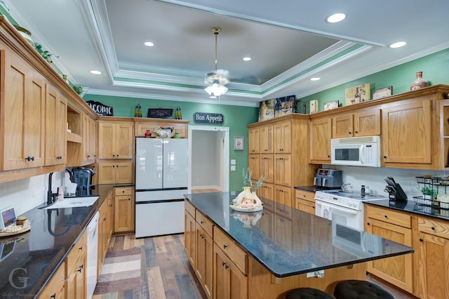 133 Downs Dr, Benton, LA 71006 - kitchen featuring white appliances, a tray ceiling, light wood-style floors, a center island, and crown molding