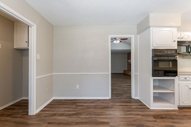 5209 Wolens Way, Fort Worth, TX 76133 - kitchen featuring oven, a ceiling fan, dark wood-type flooring, white cabinets, and a textured ceiling