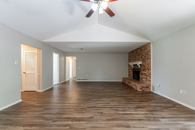 5209 Wolens Way, Fort Worth, TX 76133 - unfurnished living room with ceiling fan, vaulted ceiling, a brick fireplace, and wood finished floors