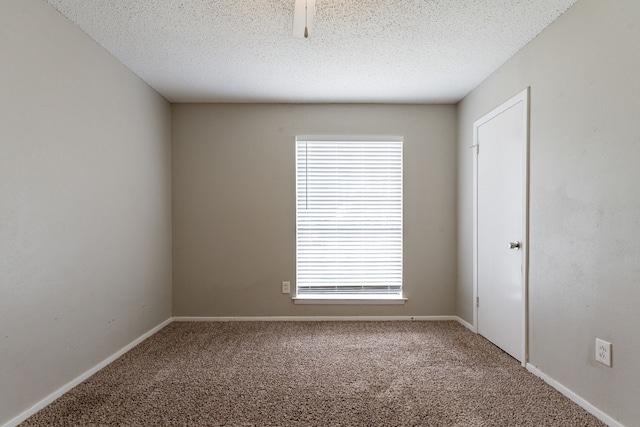 5209 Wolens Way, Fort Worth, TX 76133 - empty room with carpet, plenty of natural light, and a textured ceiling