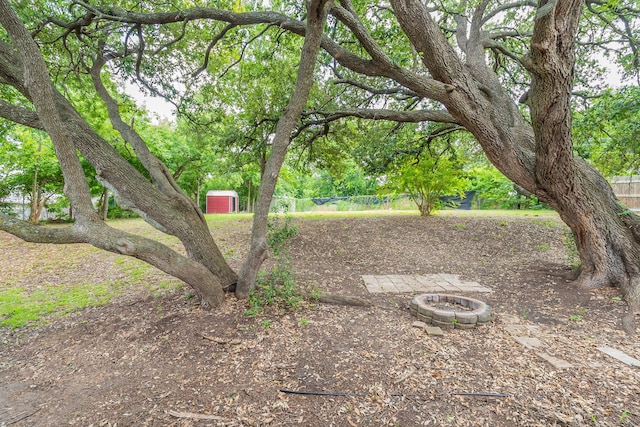 5209 Wolens Way, Fort Worth, TX 76133 - view of yard with a storage unit and an outdoor fire pit