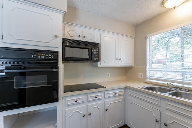 5209 Wolens Way, Fort Worth, TX 76133 - kitchen with black appliances, a textured ceiling, white cabinetry, light countertops, and a textured wall