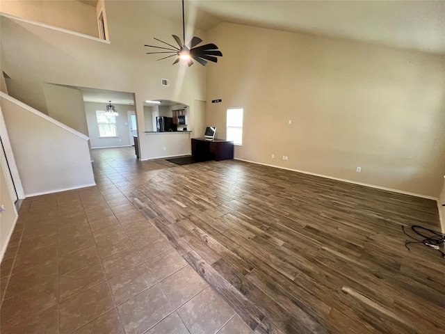 484 Harding Ln, Lavon, TX 75166 - unfurnished living room featuring a ceiling fan, healthy amount of natural light, arched walkways, high vaulted ceiling, and dark wood-type flooring