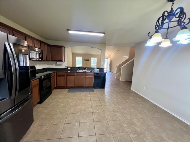 484 Harding Ln, Lavon, TX 75166 - kitchen featuring black appliances, dark countertops, light tile patterned flooring, arched walkways, and a chandelier