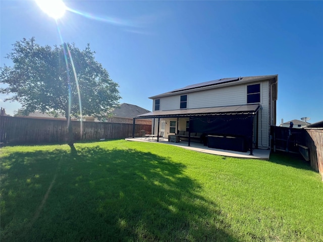 484 Harding Ln, Lavon, TX 75166 - back of house with roof mounted solar panels, a fenced backyard, a patio area, and outdoor lounge area