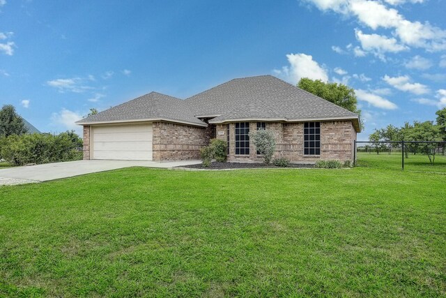 11440 Mitchell Cir, Ponder, TX 76259 - french country style house featuring a garage, driveway, brick siding, and a shingled roof