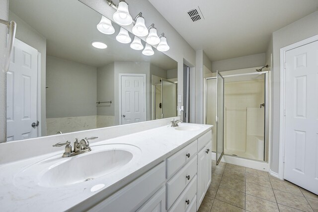 11440 Mitchell Cir, Ponder, TX 76259 - bathroom with a shower stall, double vanity, and tile patterned flooring