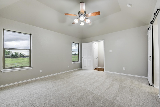 11440 Mitchell Cir, Ponder, TX 76259 - unfurnished bedroom featuring a barn door, carpet, a ceiling fan, and lofted ceiling