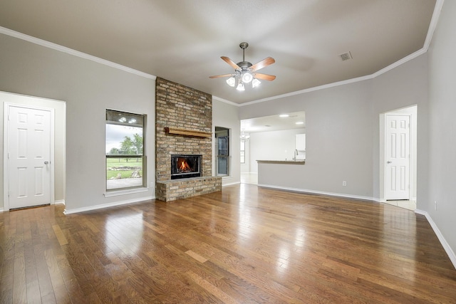 11440 Mitchell Cir, Ponder, TX 76259 - unfurnished living room featuring a ceiling fan, wood finished floors, ornamental molding, and a fireplace
