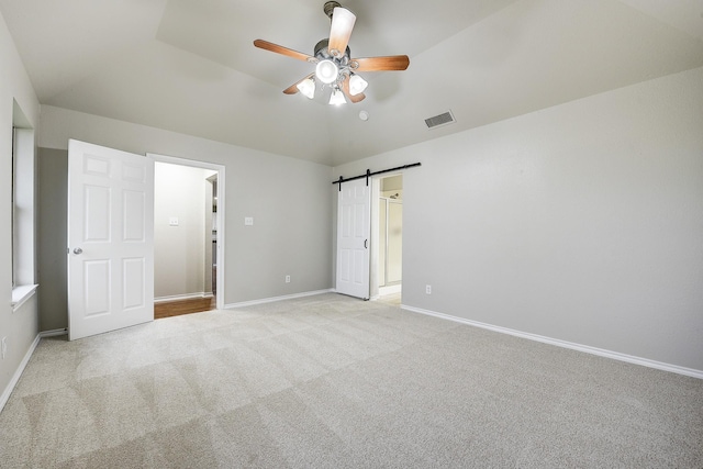 11440 Mitchell Cir, Ponder, TX 76259 - unfurnished bedroom with light carpet, vaulted ceiling, a barn door, and ceiling fan