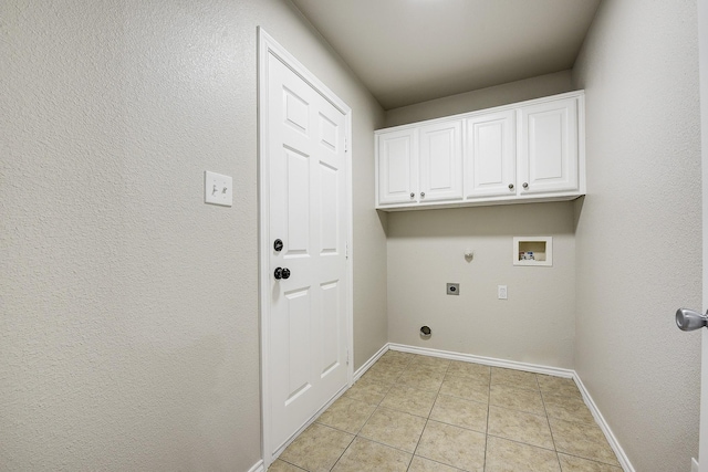 11440 Mitchell Cir, Ponder, TX 76259 - laundry area with hookup for an electric dryer, light tile patterned floors, washer hookup, gas dryer hookup, and cabinet space