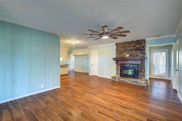 1521 Church St, Sulphur Springs, TX 75482 - unfurnished living room featuring ornamental molding, dark wood-style floors, a ceiling fan, and a stone fireplace