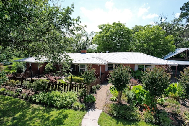 1521 Church St, Sulphur Springs, TX 75482 - ranch-style home with a metal roof, a chimney, and brick siding