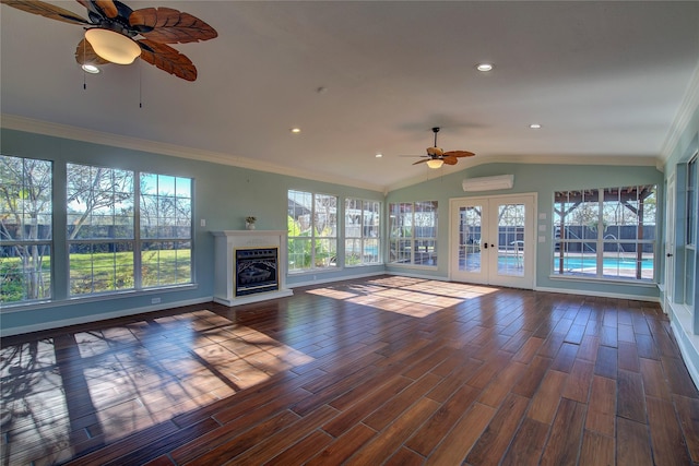 1521 Church St, Sulphur Springs, TX 75482 - unfurnished living room featuring a ceiling fan, french doors, a wall unit AC, wood finished floors, and lofted ceiling