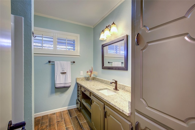 1521 Church St, Sulphur Springs, TX 75482 - bathroom with crown molding, vanity, wood tiled floors, and plenty of natural light