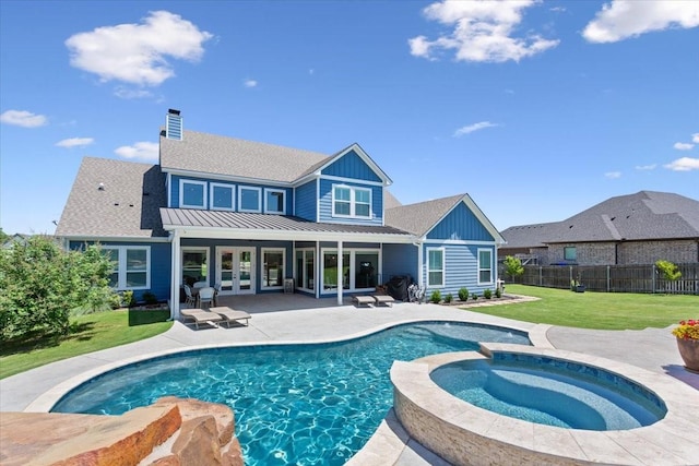 400 Wycliff Dr, China Spring, TX 76633 - back of house featuring a patio, a standing seam roof, a pool with connected hot tub, board and batten siding, and a metal roof