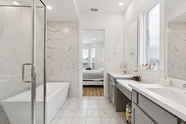 1814 Cypress Gap Trl, Mansfield, TX 76063 - bathroom with marble look tiles, vanity, a freestanding bath, connected bathroom, and a shower stall