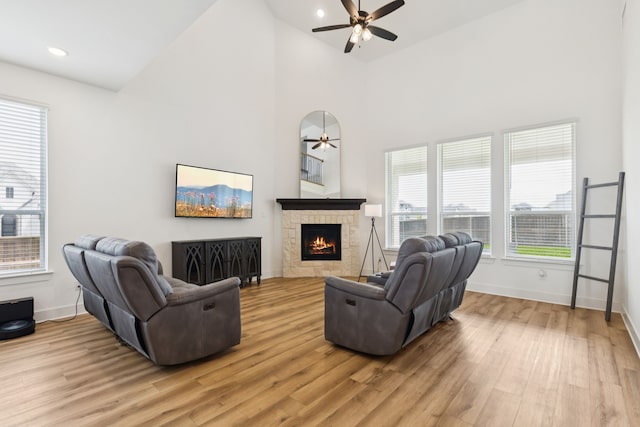 1814 Cypress Gap Trl, Mansfield, TX 76063 - living room with light wood-type flooring, ceiling fan, a stone fireplace, high vaulted ceiling, and recessed lighting