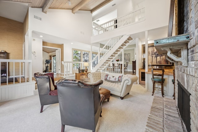 6250 Twin Oaks Cir, Dallas, TX 75240 - living room featuring stairway, carpet, a brick fireplace, a high ceiling, and a wooden ceiling with exposed beams