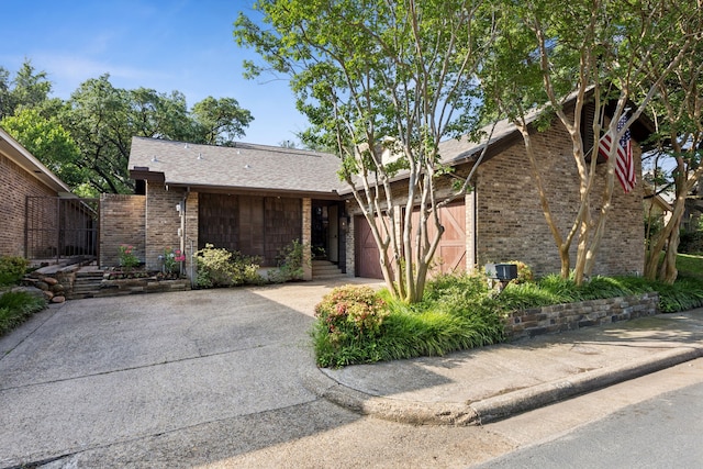 6250 Twin Oaks Cir, Dallas, TX 75240 - view of front of house with concrete driveway, brick siding, and an attached garage