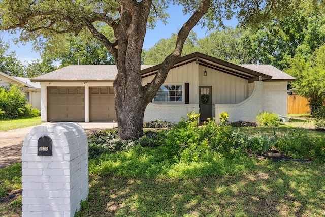 4632 Ivanhoe Dr, Fort Worth, TX 76132 - mid-century modern home featuring driveway, a garage, and brick siding