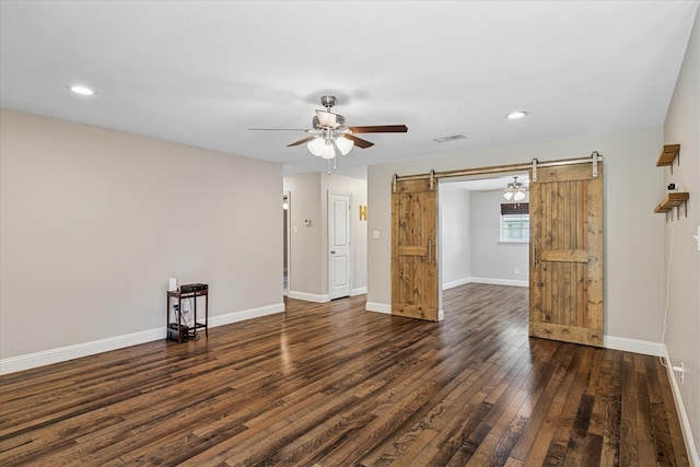4632 Ivanhoe Dr, Fort Worth, TX 76132 - empty room with a barn door, a ceiling fan, dark wood-style floors, and recessed lighting