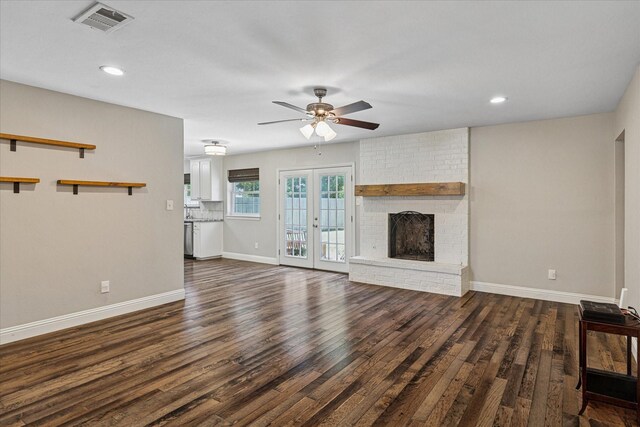 4632 Ivanhoe Dr, Fort Worth, TX 76132 - unfurnished living room featuring a ceiling fan, dark wood-style flooring, a brick fireplace, french doors, and recessed lighting