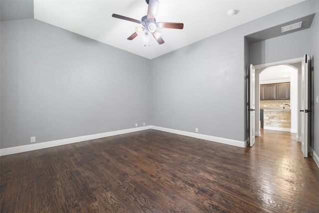 1020 Perennial Ln, Little Elm, TX 75068 - empty room with arched walkways, a ceiling fan, dark wood-style floors, lofted ceiling, and a smoke detector