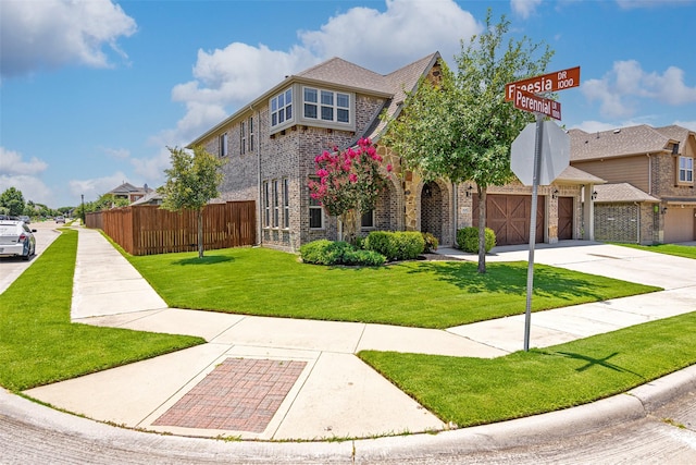1020 Perennial Ln, Little Elm, TX 75068 - view of front of home with brick siding, concrete driveway, and an attached garage