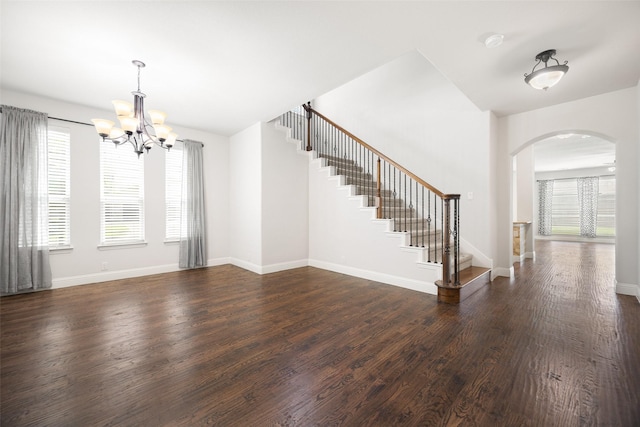1020 Perennial Ln, Little Elm, TX 75068 - entrance foyer featuring arched walkways, dark wood-style floors, stairs, and a chandelier