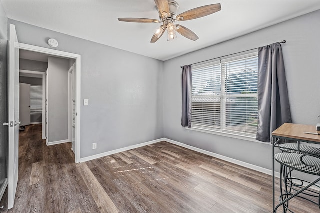 1007 College Ave, Glen Rose, TX 76043 - spare room with a smoke detector, wood finished floors, and ceiling fan