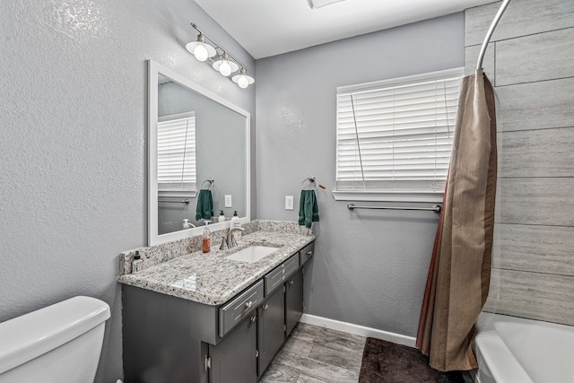 1007 College Ave, Glen Rose, TX 76043 - full bath featuring vanity, wood finished floors, and a textured wall