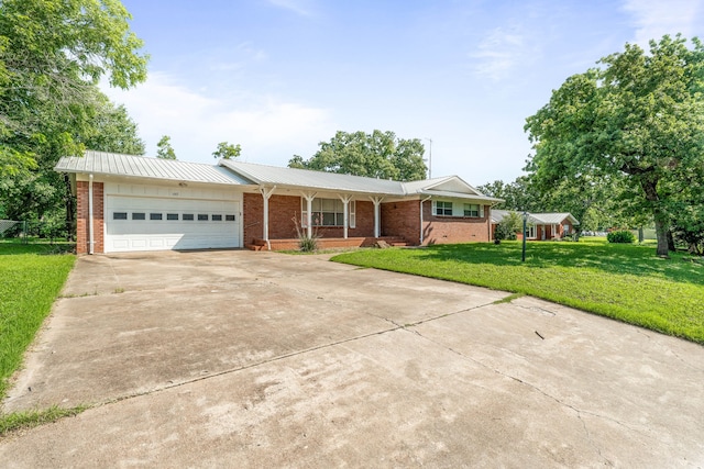 1007 College Ave, Glen Rose, TX 76043 - ranch-style home with brick siding, concrete driveway, a garage, a front yard, and a metal roof