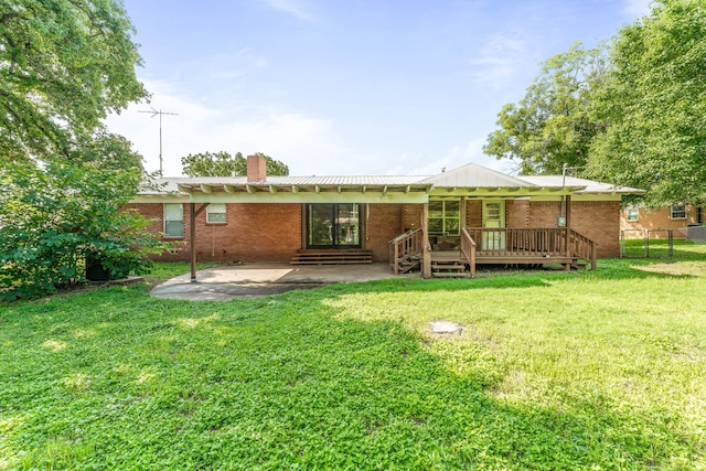 1007 College Ave, Glen Rose, TX 76043 - rear view of house with a chimney, brick siding, a patio area, and a wooden deck