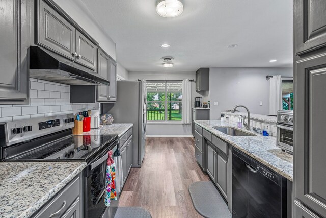 1007 College Ave, Glen Rose, TX 76043 - kitchen with stainless steel electric stove, gray cabinetry, black dishwasher, and recessed lighting