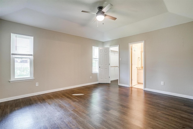 555 Meadowbrook Dr, Burleson, TX 76028 - unfurnished bedroom featuring dark wood-style floors, a walk in closet, ensuite bathroom, ceiling fan, and a closet