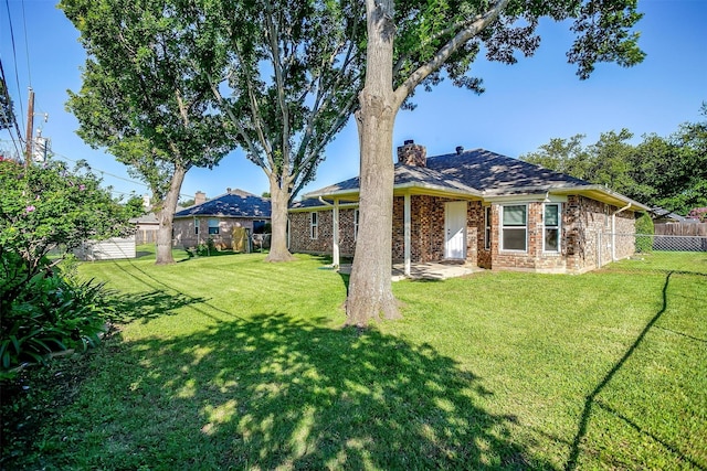555 Meadowbrook Dr, Burleson, TX 76028 - rear view of house featuring a fenced backyard, brick siding, and a chimney