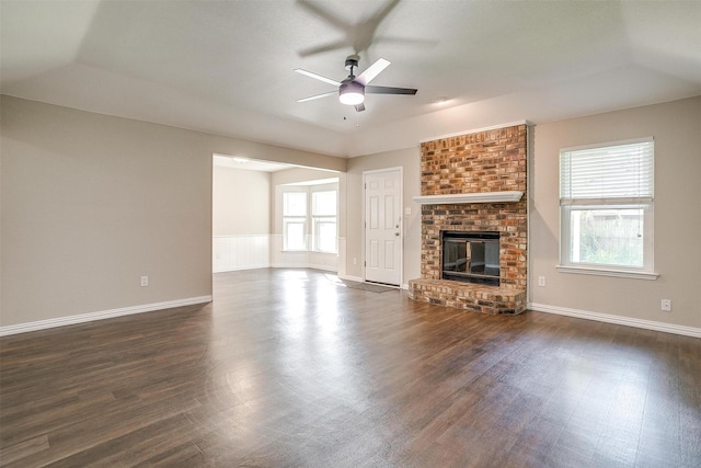 555 Meadowbrook Dr, Burleson, TX 76028 - unfurnished living room featuring ceiling fan, dark wood-style flooring, and a fireplace